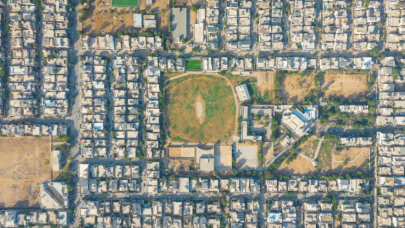 Aerial view of a residential area with a sports field
