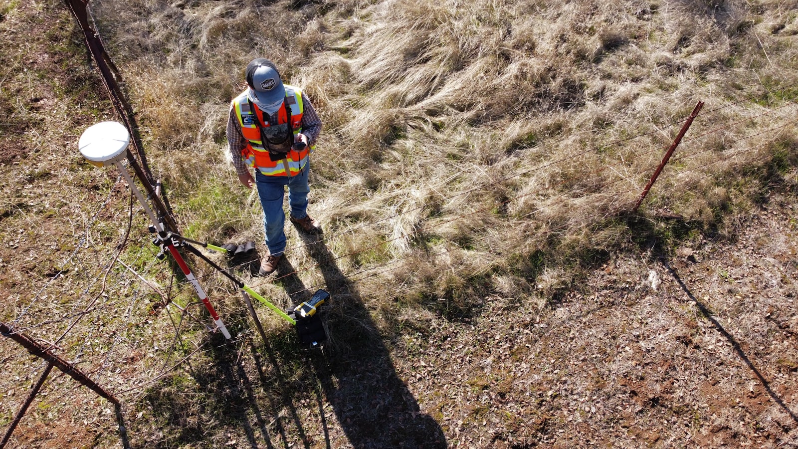 Surveyor on a dirt road representing the affordable plots in Electronic City buyer's guide