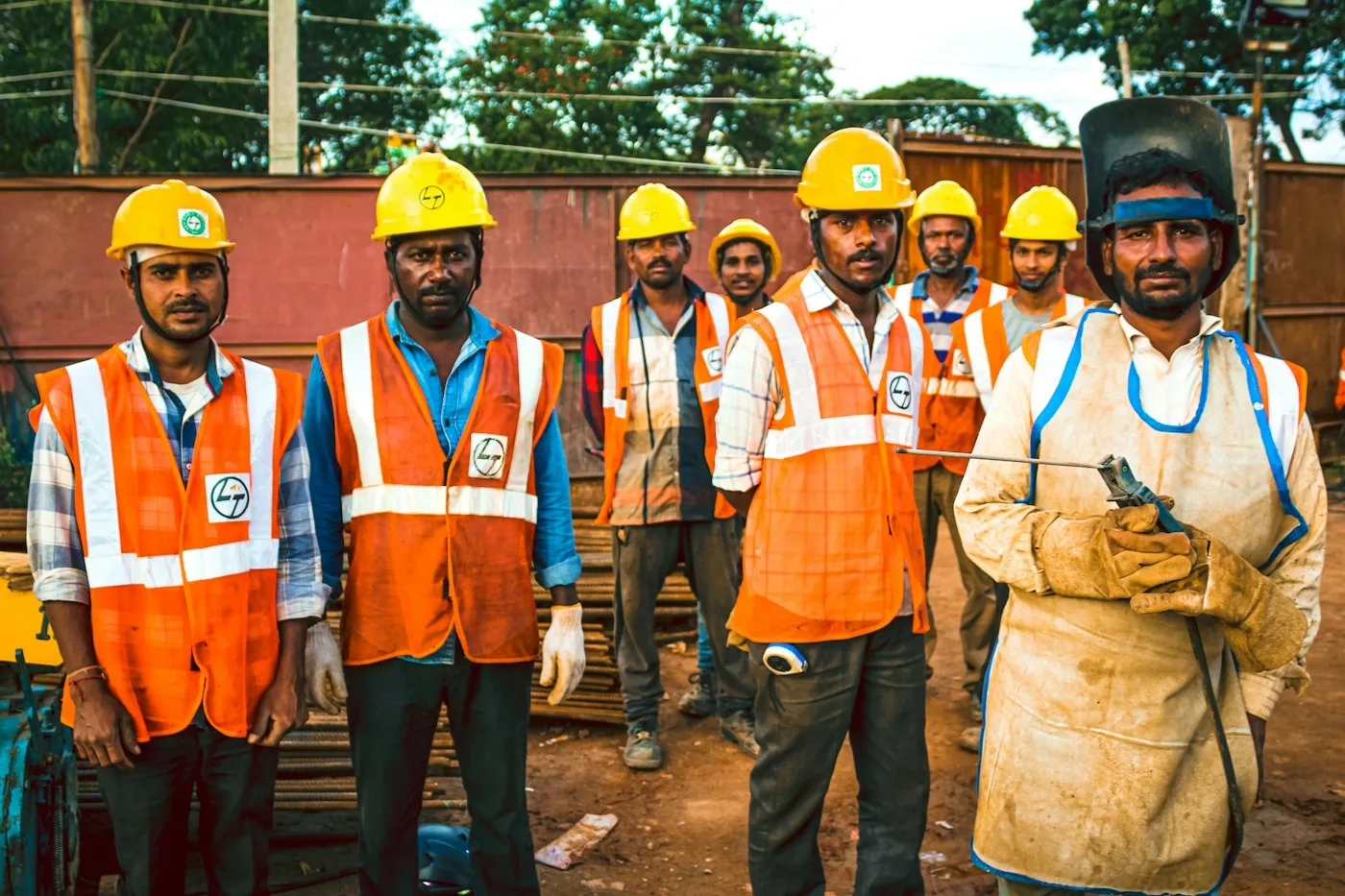 Workers wearing reflective vests and hard helmets