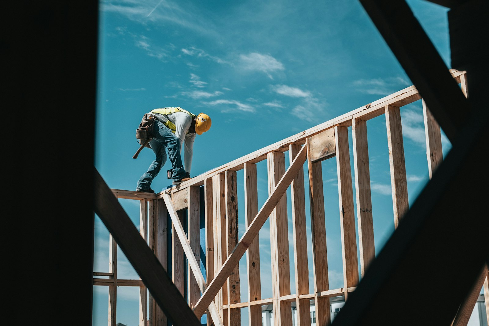 Construction worker on a building frame representing Anelkal real estate trends, demand and investment