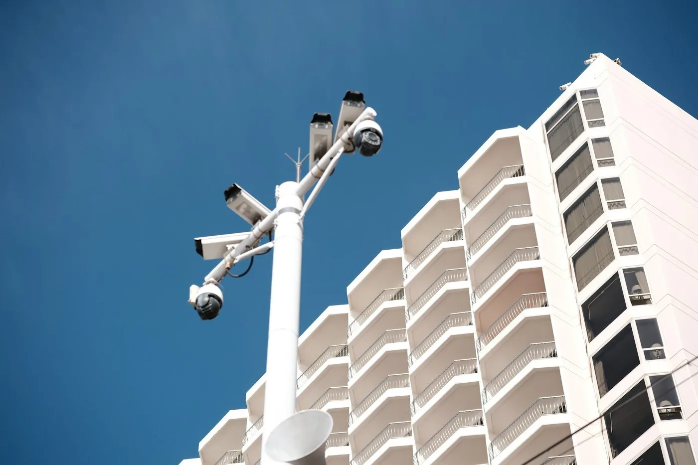 Security cameras mounted on a pole near a building