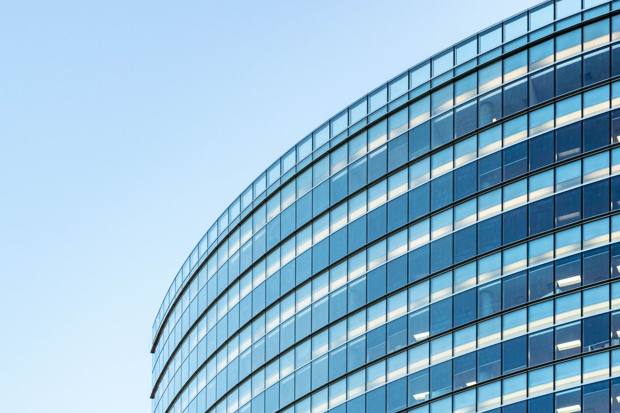 Modern glass IT office building against a clear sky