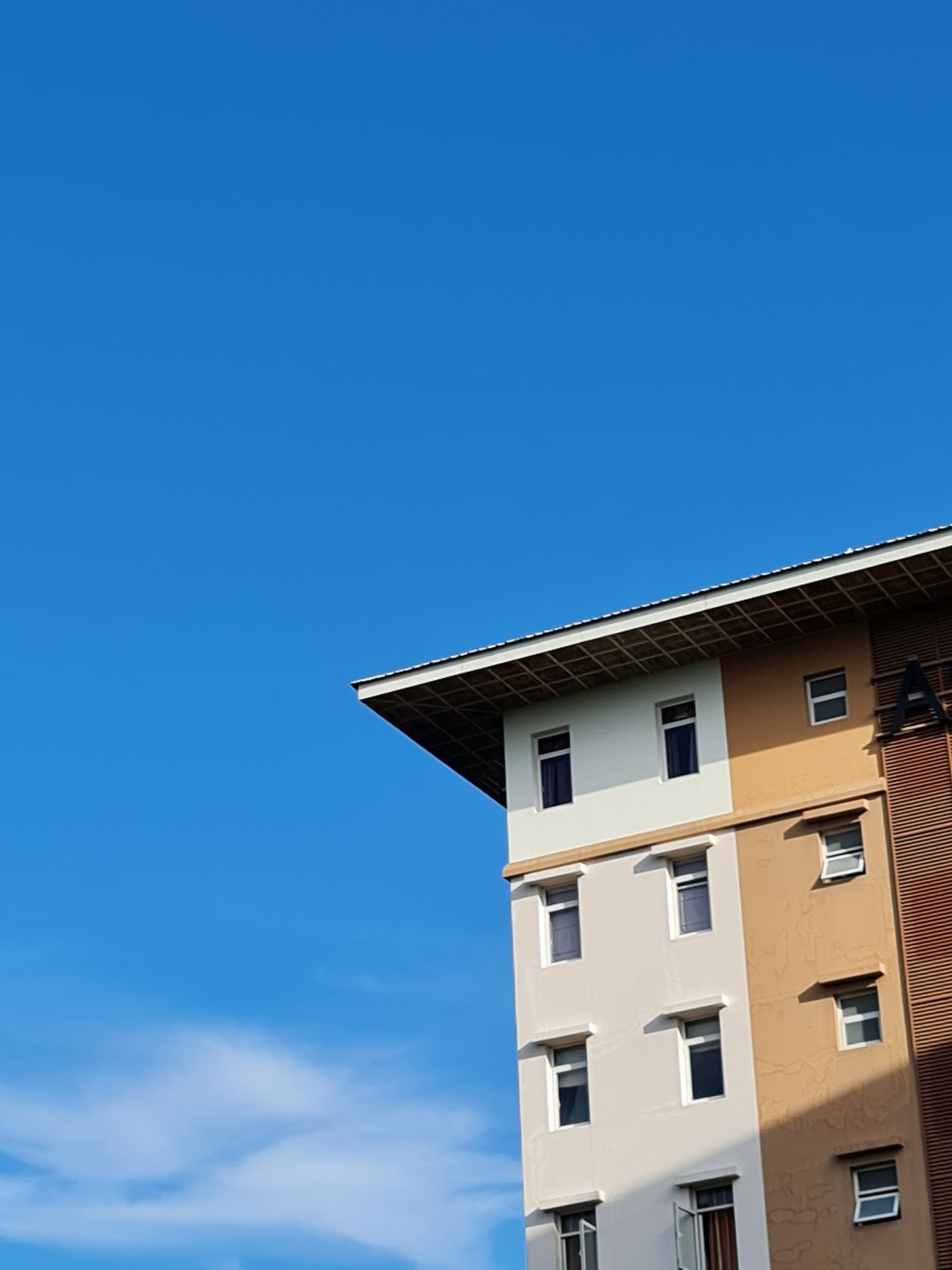 Modern apartment building under a clear blue sky