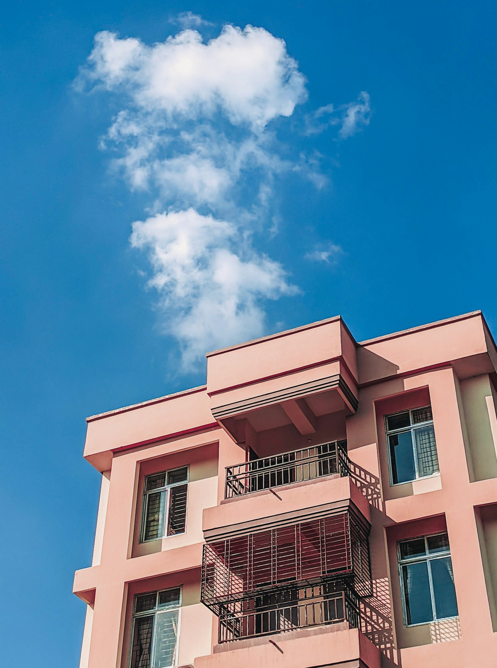 Concrete building under blue sky representing finding BDA sites for sale in Bangalore