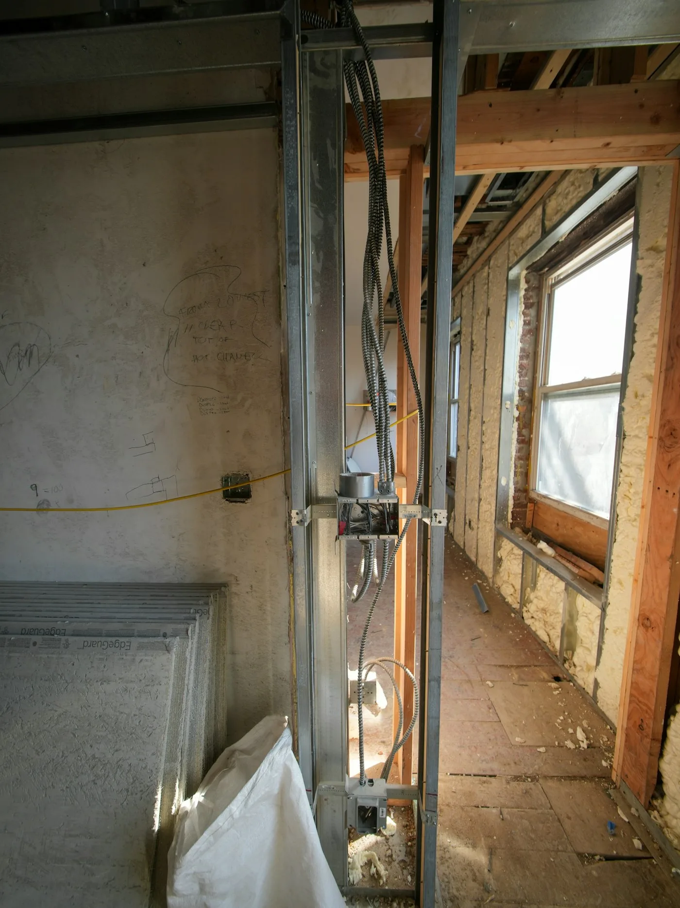 Construction hallway with exposed wiring and studs