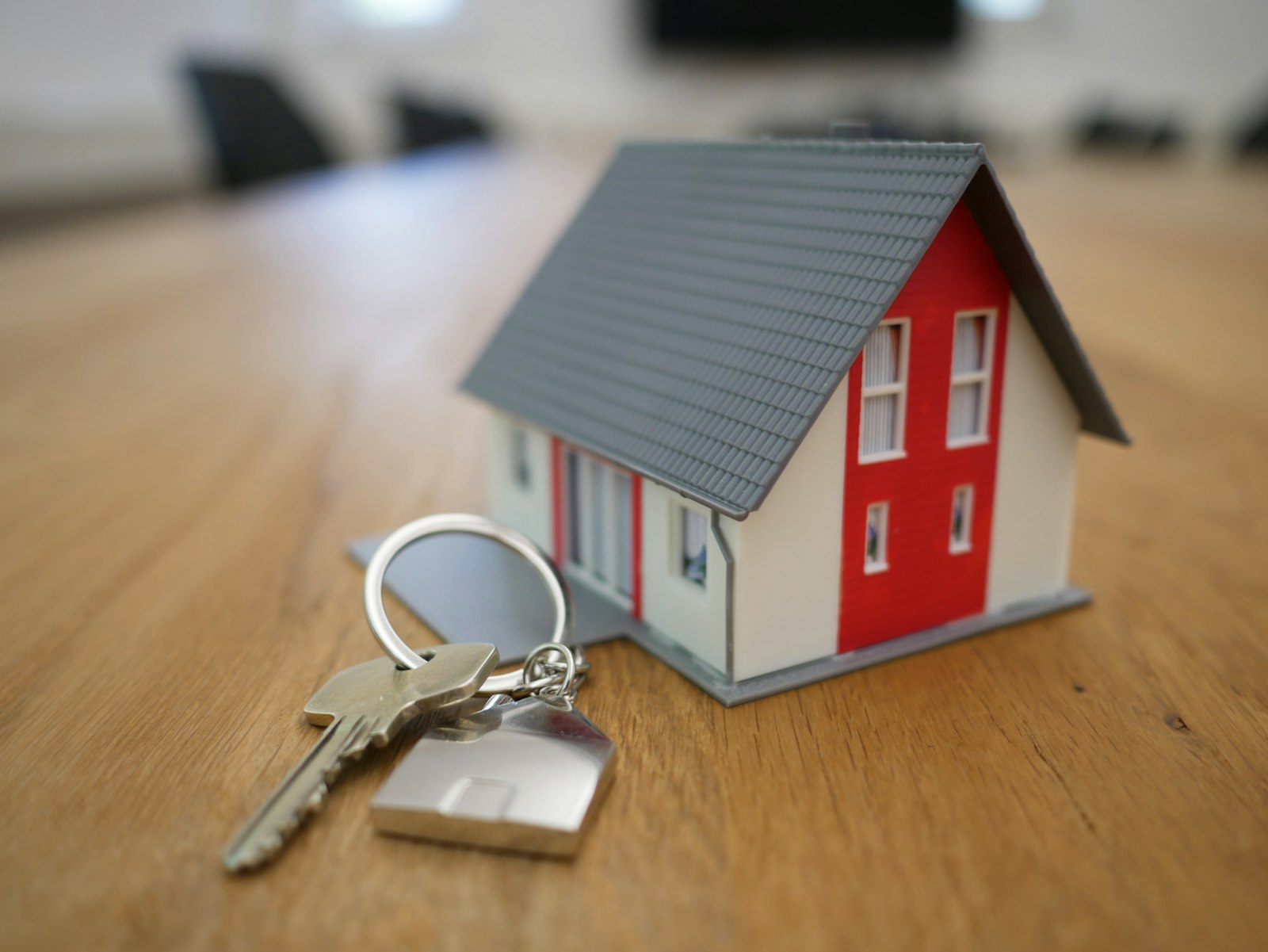 House model on a table representing the e-Khata online application process in Karnataka