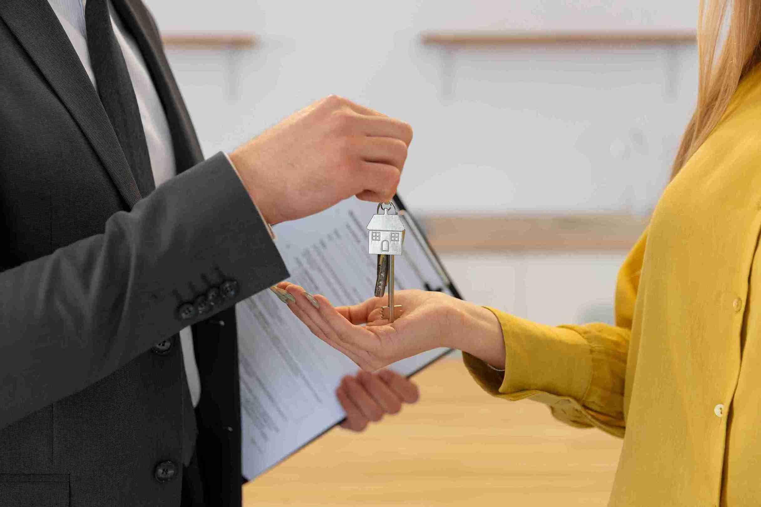 male-real-estate-agent-giving-keys-new-house-female-buyer_11zon