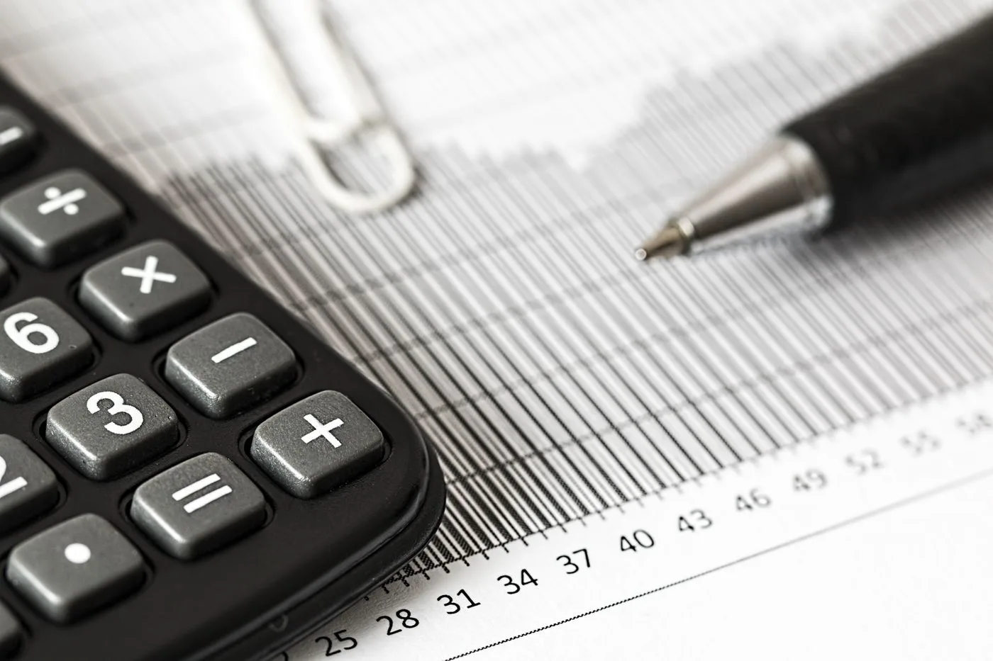 Calculator and pen on a table