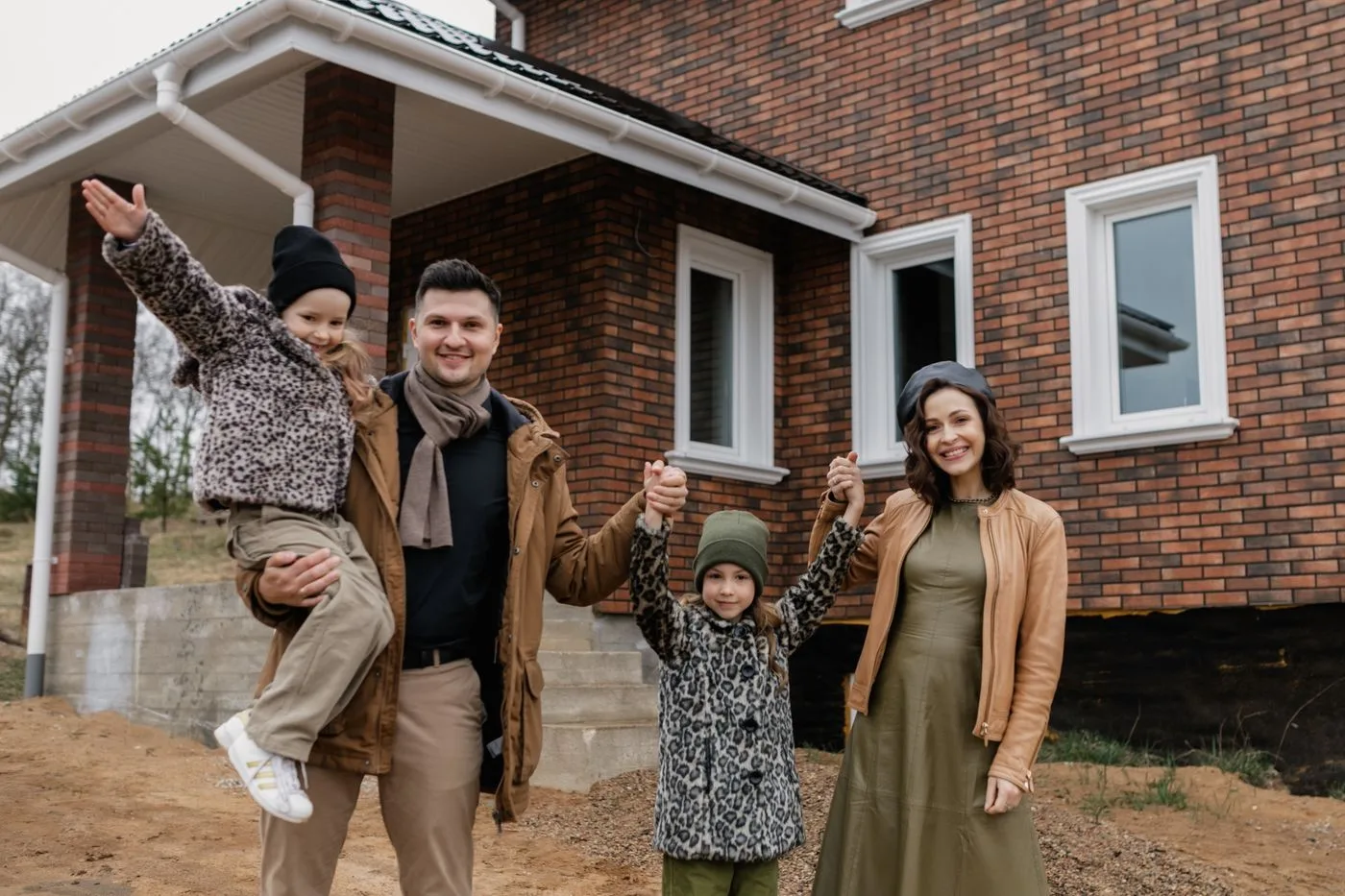 Family standing in front of their new house