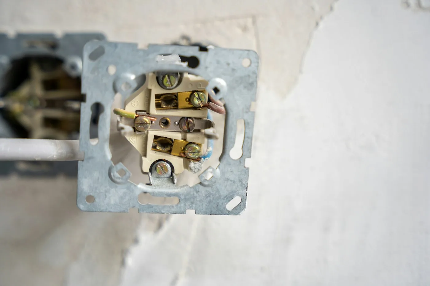 Electrical outlet taken apart to show the wiring