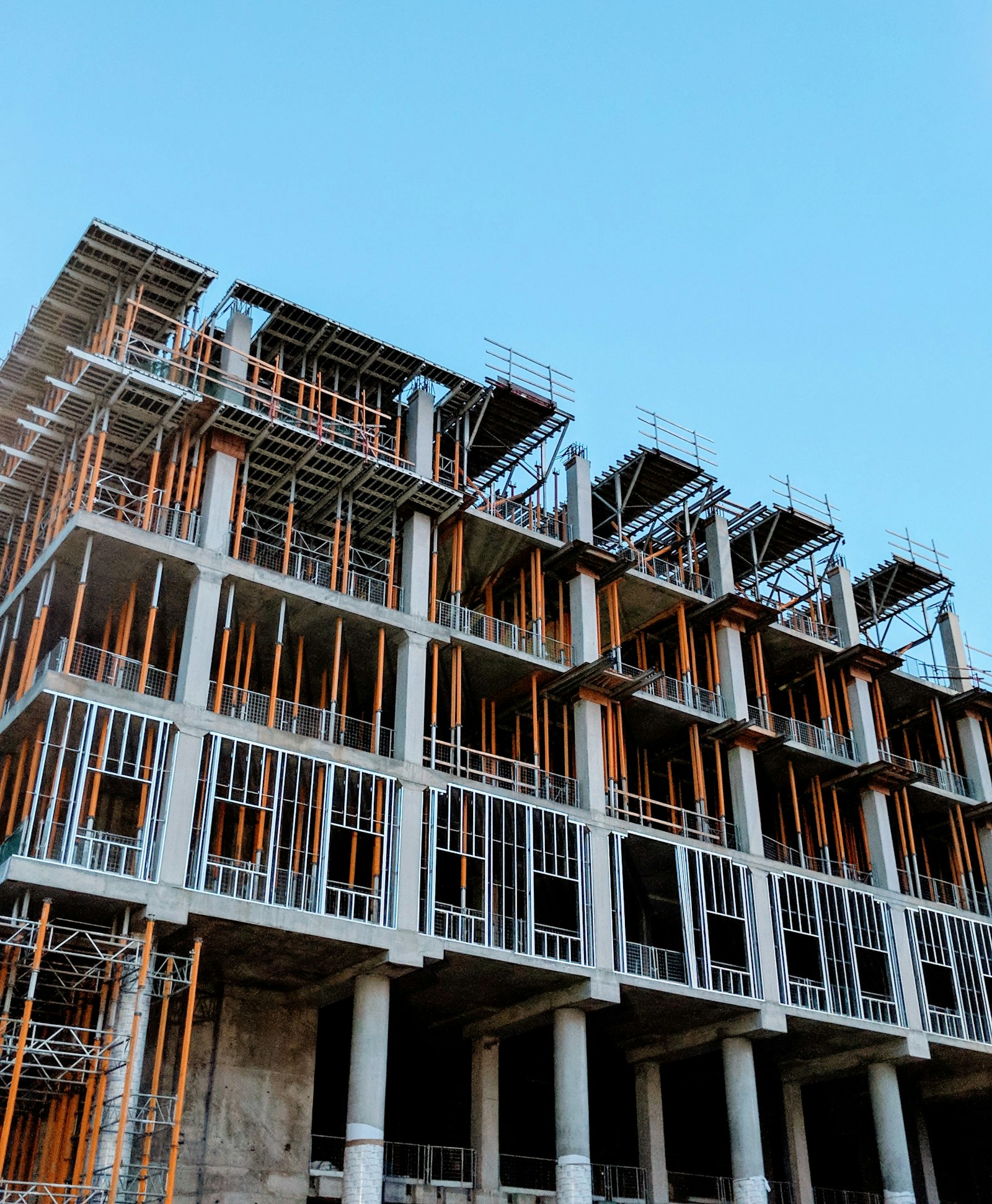 Gray concrete building under construction representing the Jakkur real estate property prices and investment guide