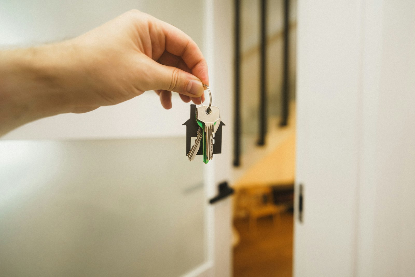 Hand holding a door key representing the Karnataka Land Revenue Act 1964
