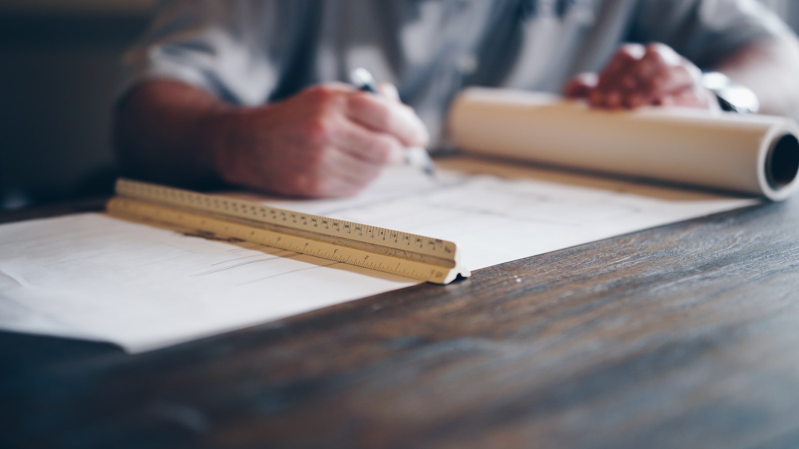Person drafting building plan blueprint