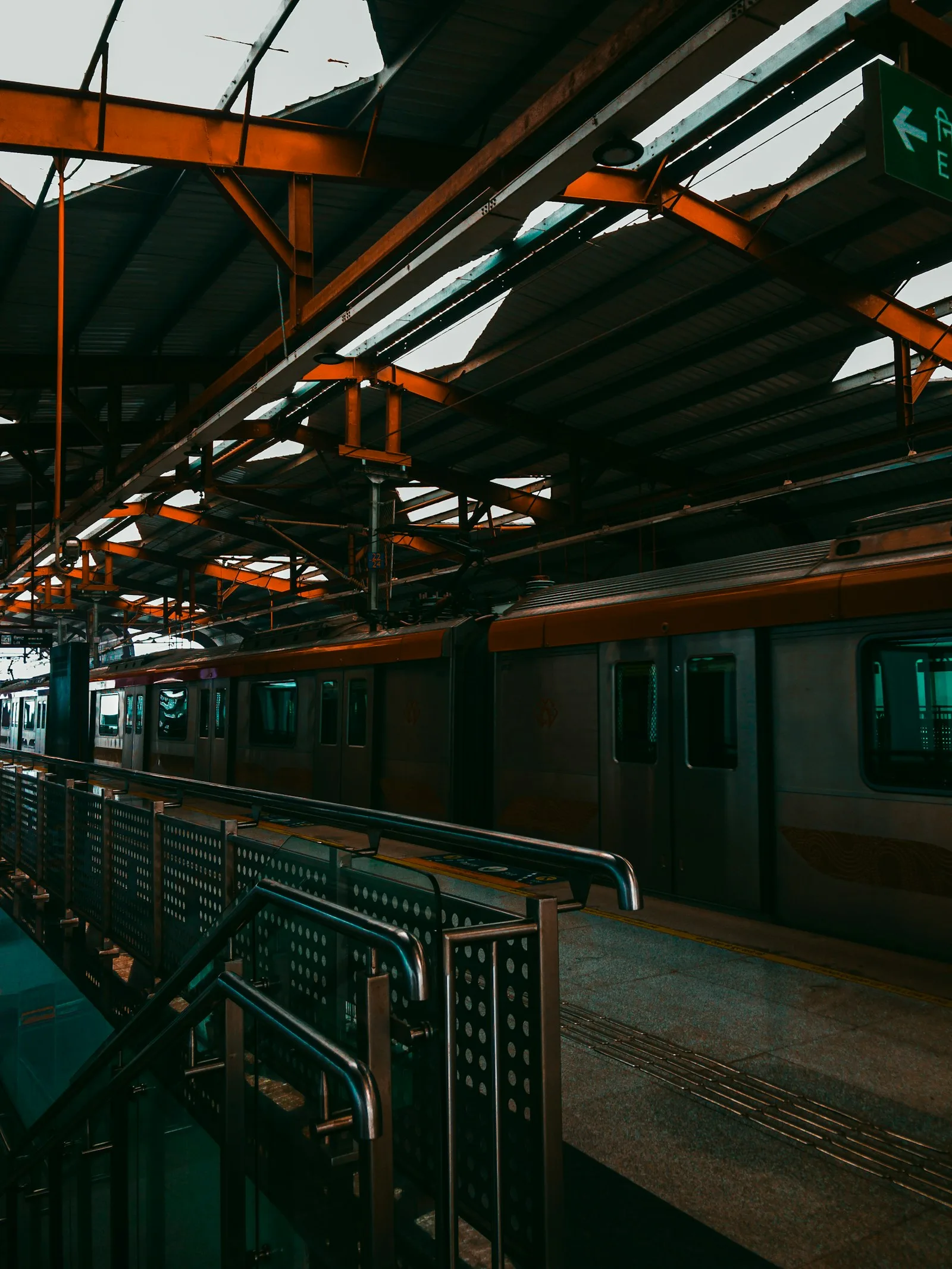 Train station with a metro train parked next to it