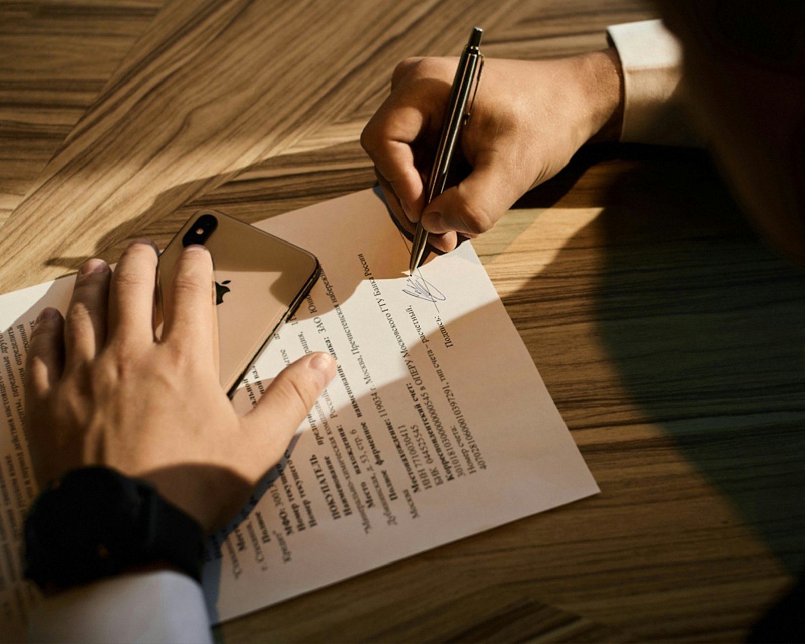 Person writing on paper representing what a mother deed in property means in the Karnataka buyer guide