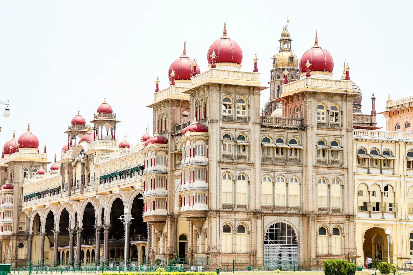Red-domed building with Mysore Palace in the background