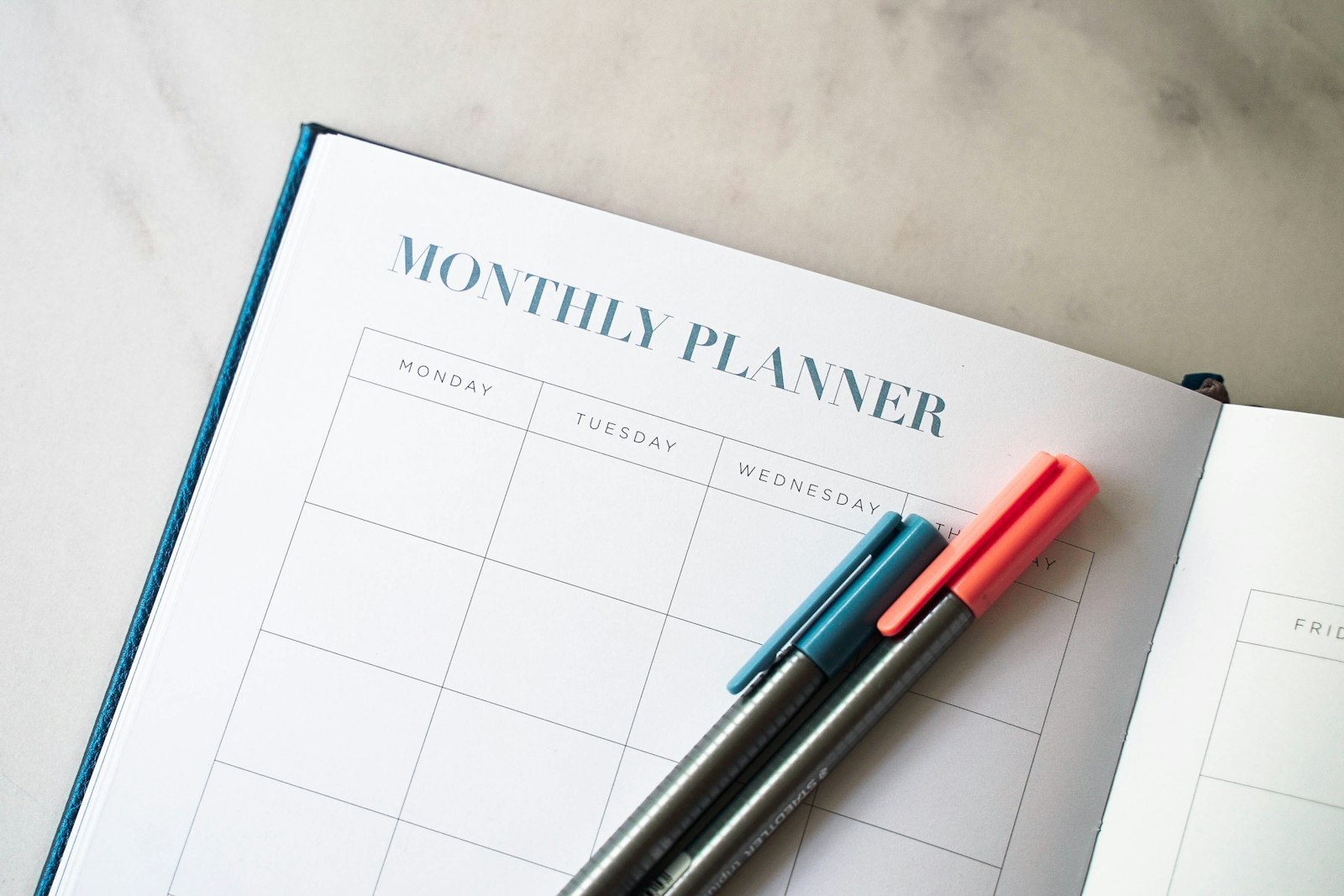 Planner with pens representing the NRI property buying guide for India Bangalore investment resource