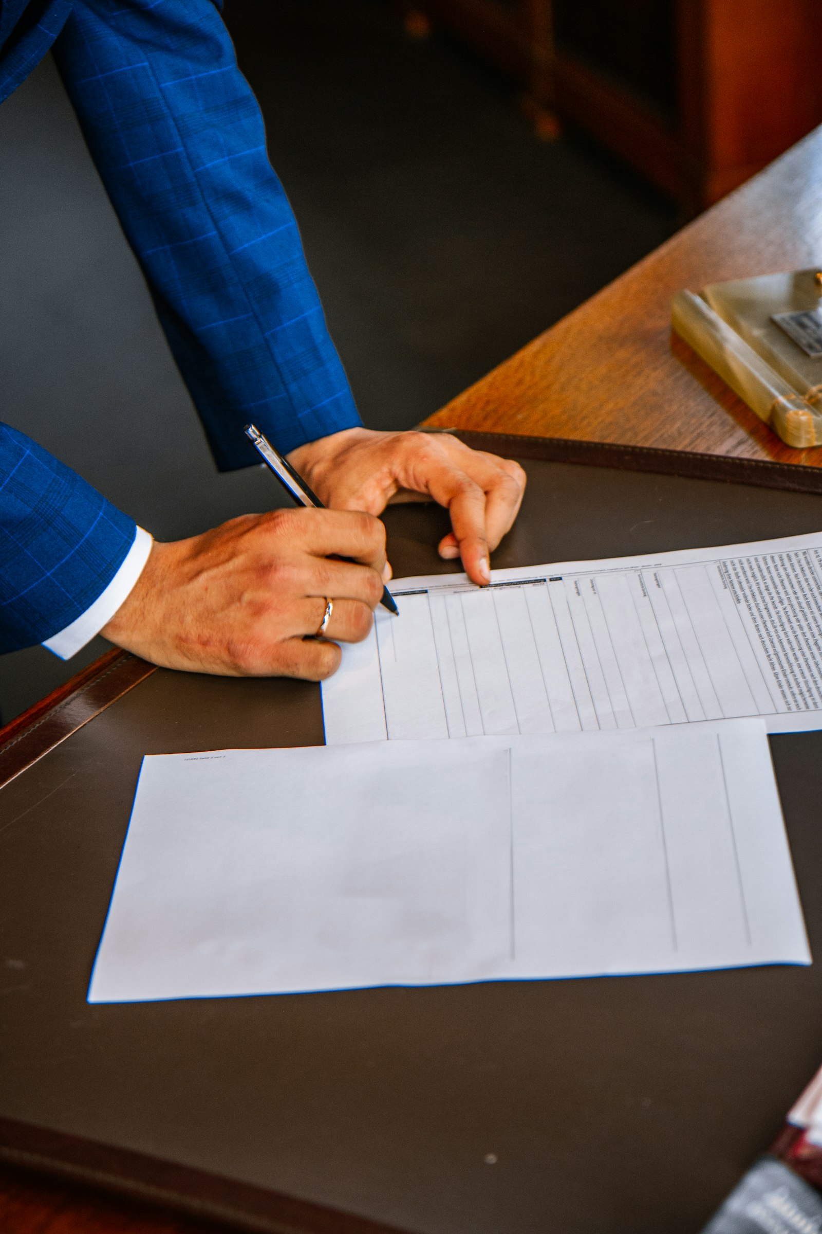 Form being completed representing legal requirements for NRI property investment in Karnataka