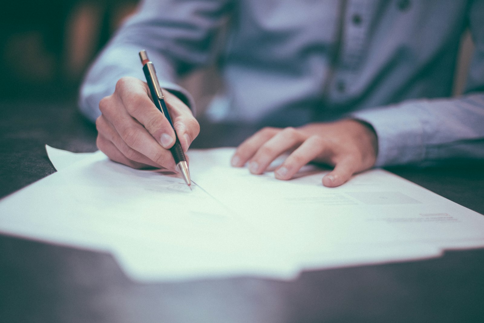 Signing a Power of Attorney document for an NRI property purchase in Mangalore