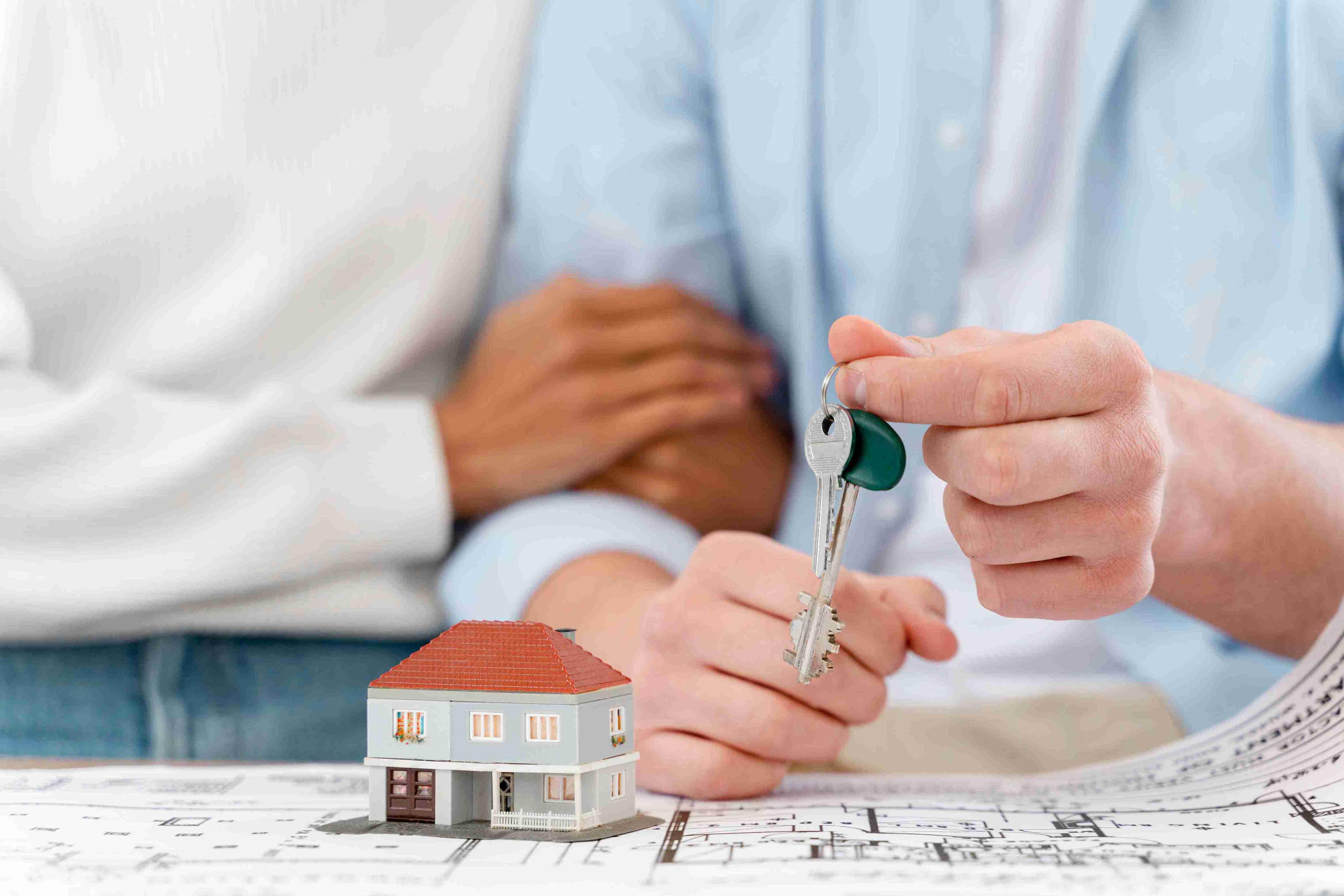 embraced-defocused-couple-holding-keys-their-new-house_11zon