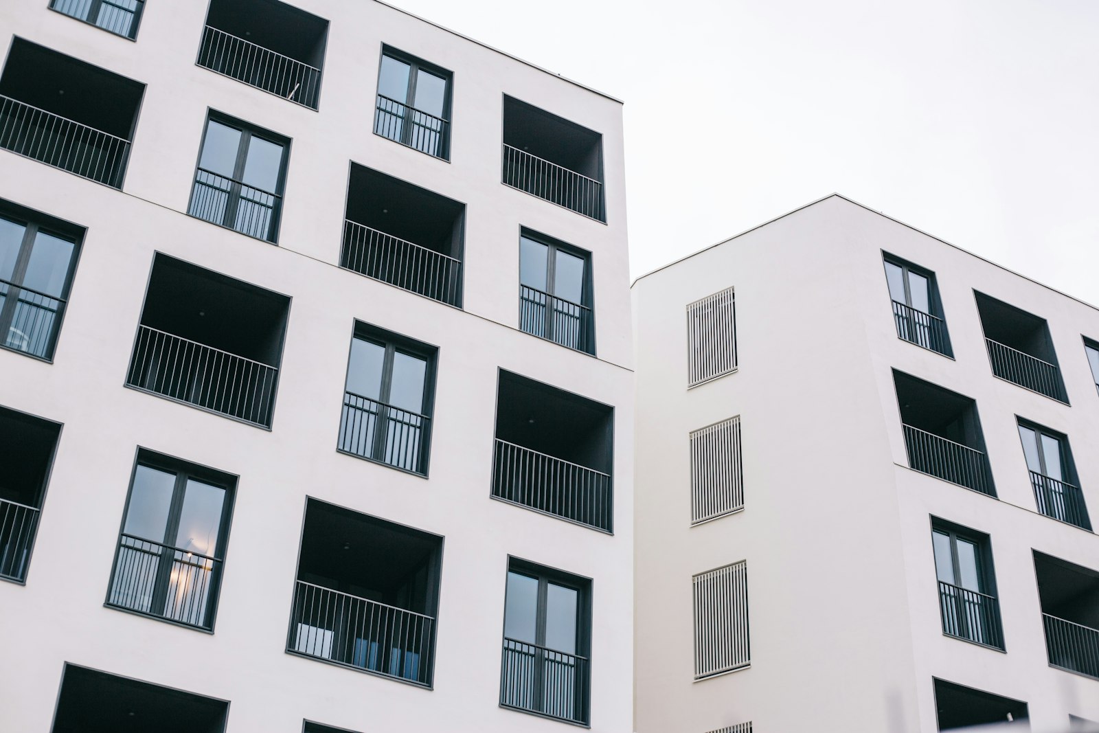 White concrete building representing property laws and land measurement in Karnataka
