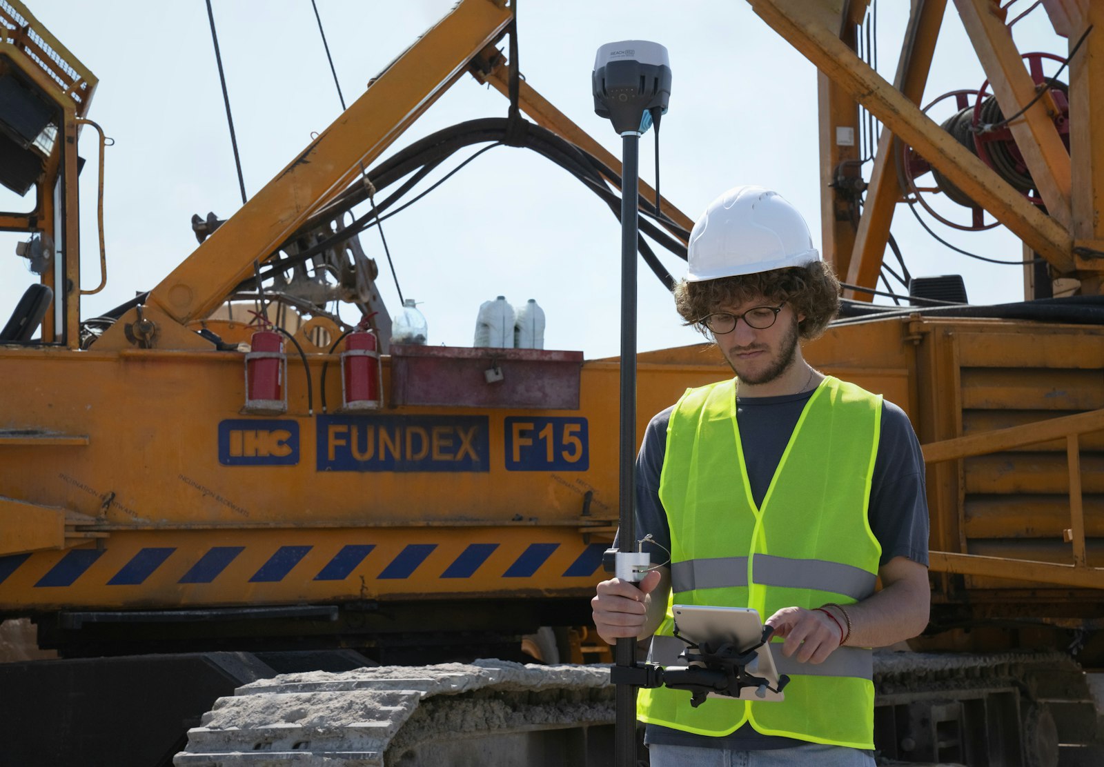 Land surveyor beside equipment representing why Sarjapur Road is a hotspot for plot investment in Bangalore