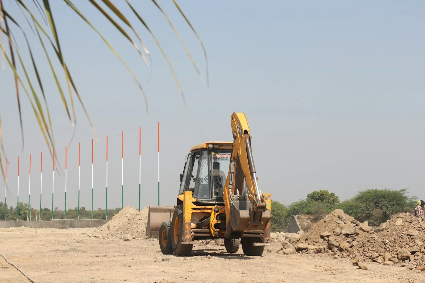 Yellow and black excavator on sand in daytime