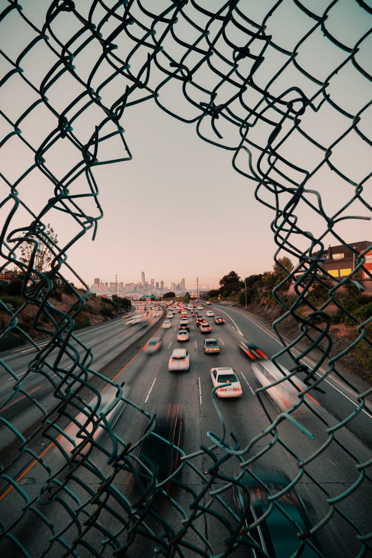Traffic flowing on an open highway at sunset