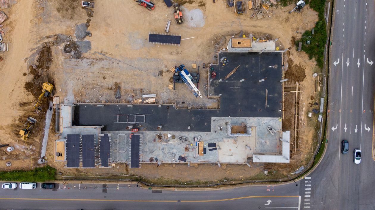 Aerial view of an active road construction site with machinery