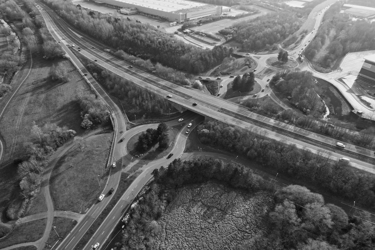 Aerial view of a road network winding through countryside near forest