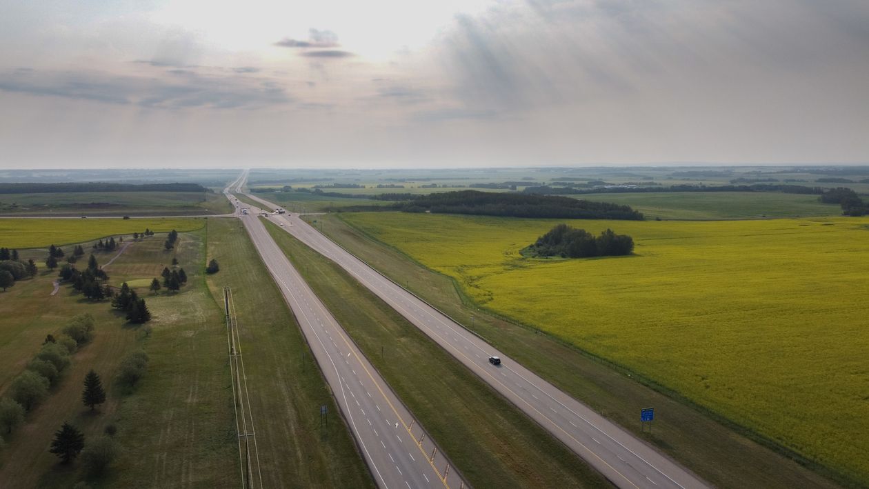 Aerial view of a highway running through open rural fields