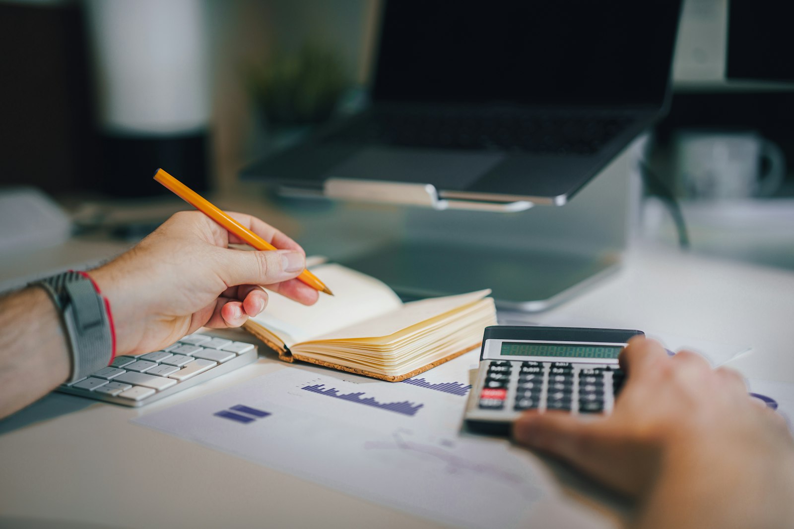 Desk with a calculator and notebook representing the top 20 best Bangalore projects 2026 where to invest and live