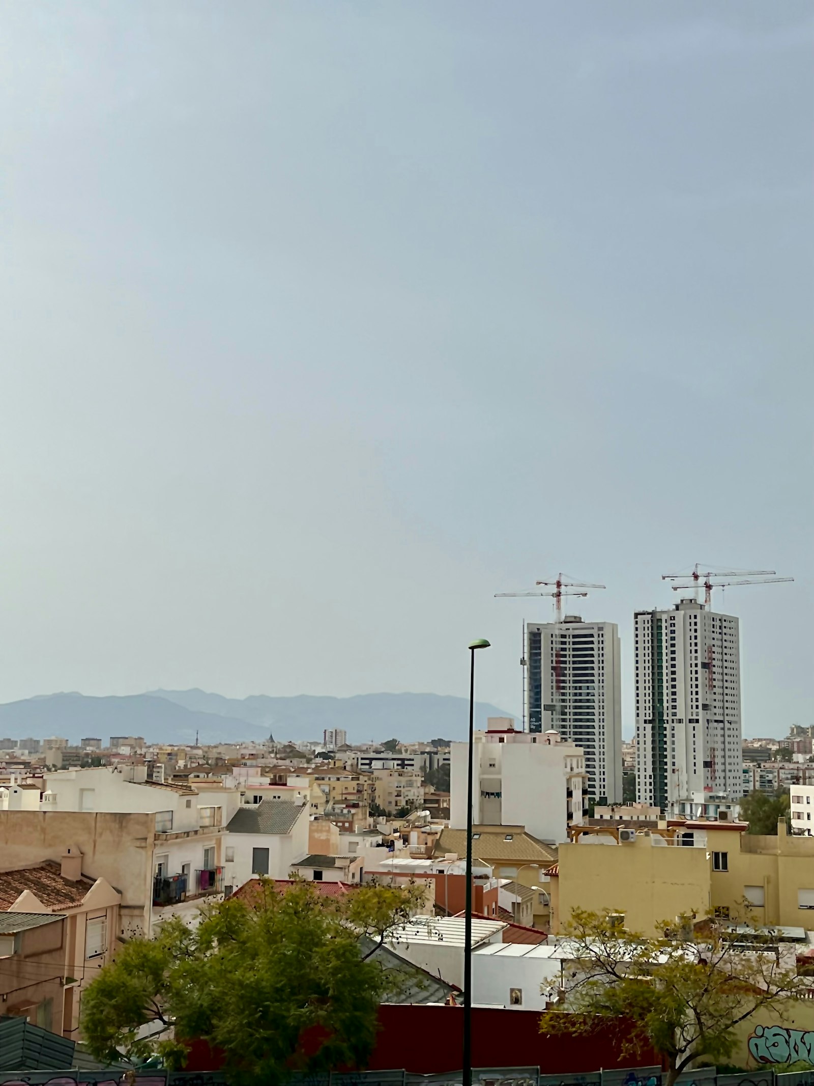 City skyline with construction cranes representing Mangalore upcoming projects
