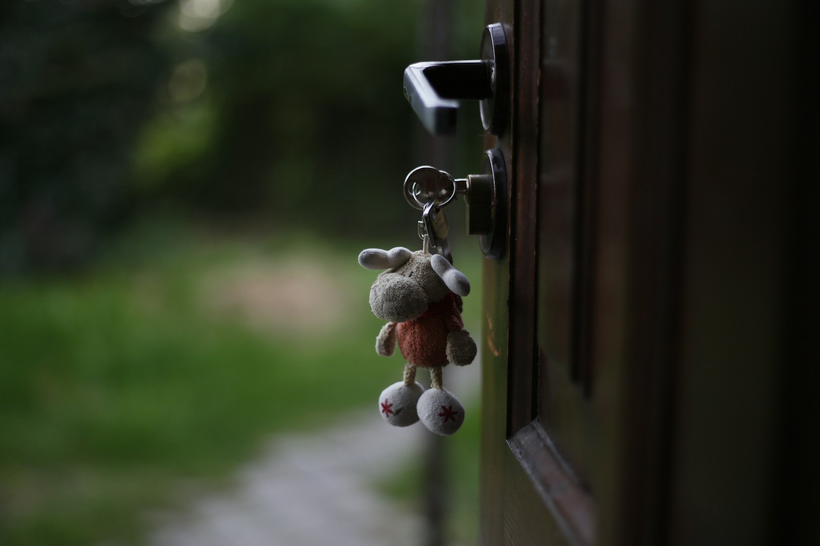 Key chain on a door handle representing verifying property documents in Karnataka