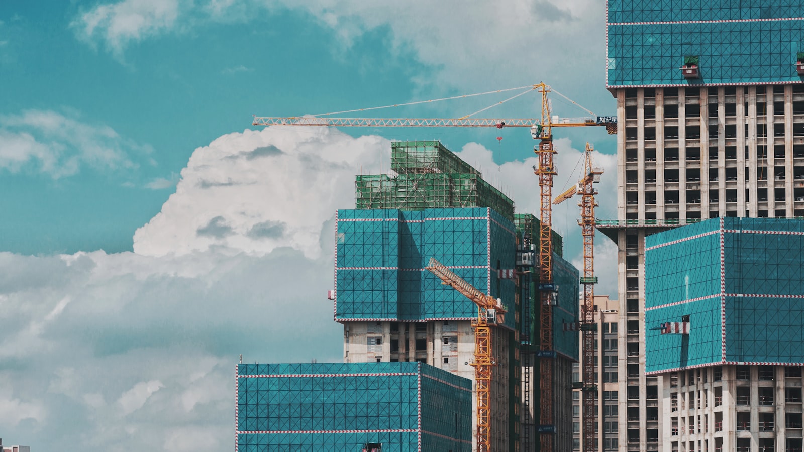 Tall buildings under a cloudy sky representing the Yelahanka real estate market