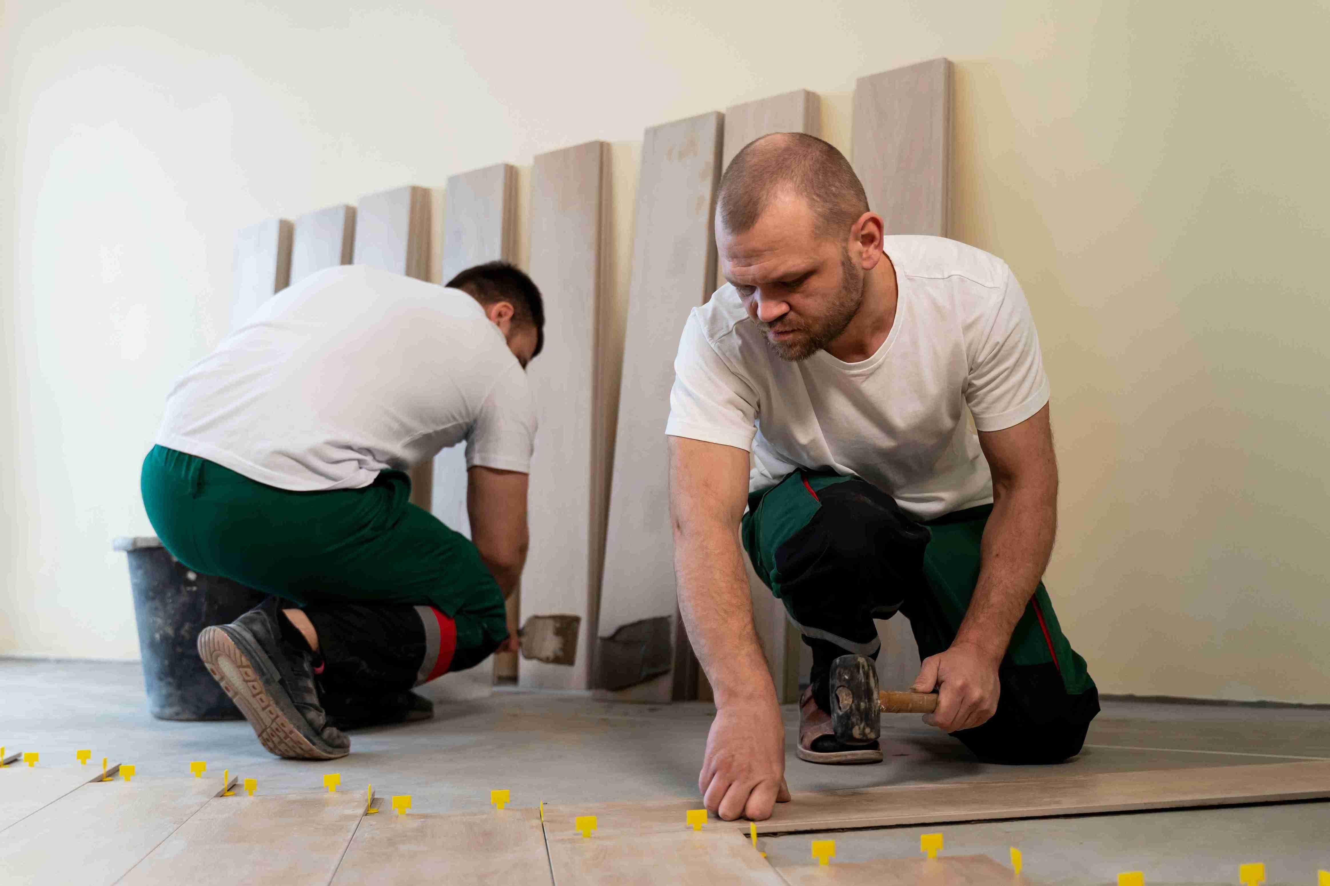 full-shot-workers-tiling-floor-indoors_11zon