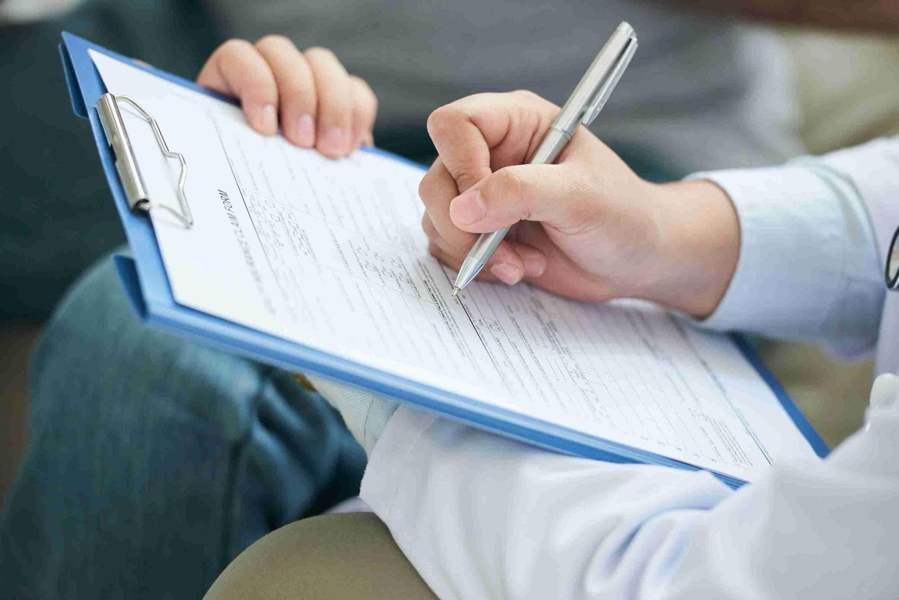 hands-unrecognizable-female-doctor-filling-form-clipboard_11zon