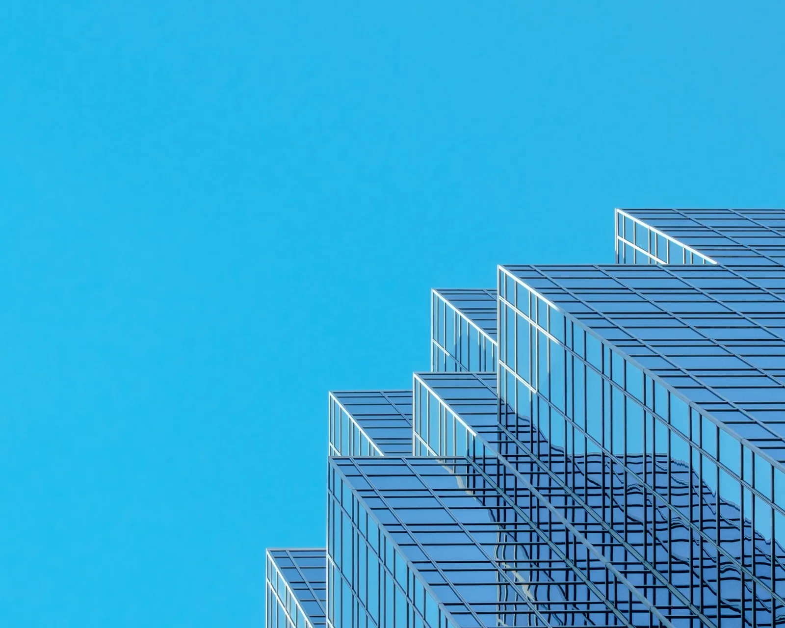 Modern glass skyscraper with a stepped facade used as an illustration