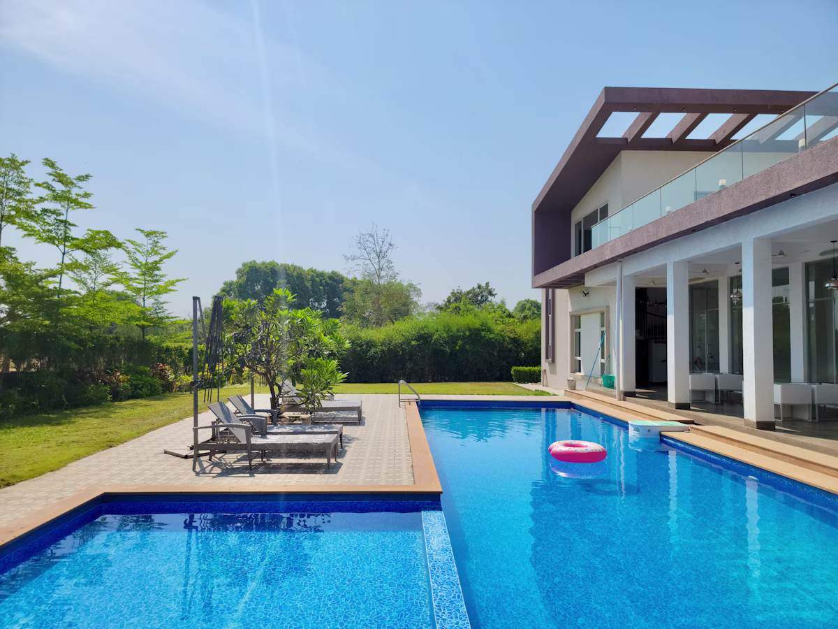 Swimming pool with deck and lounge chairs