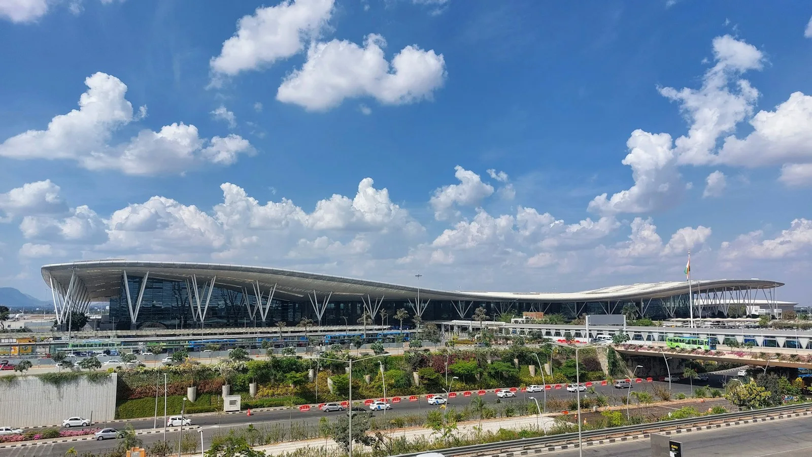 Kempegowda International Airport terminal exterior under a cloudy sky