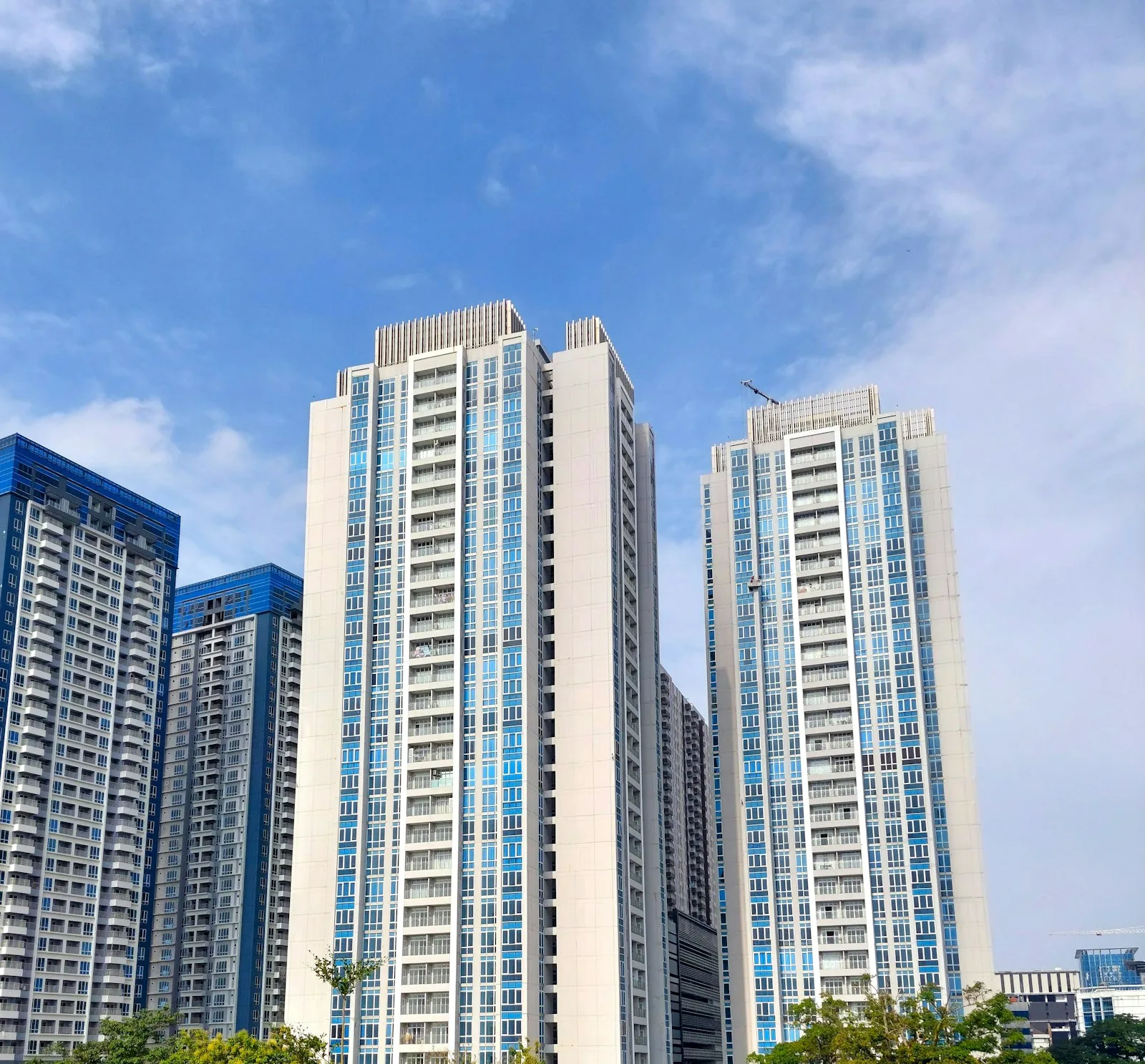 White residential apartment towers against a blue sky used as an illustration