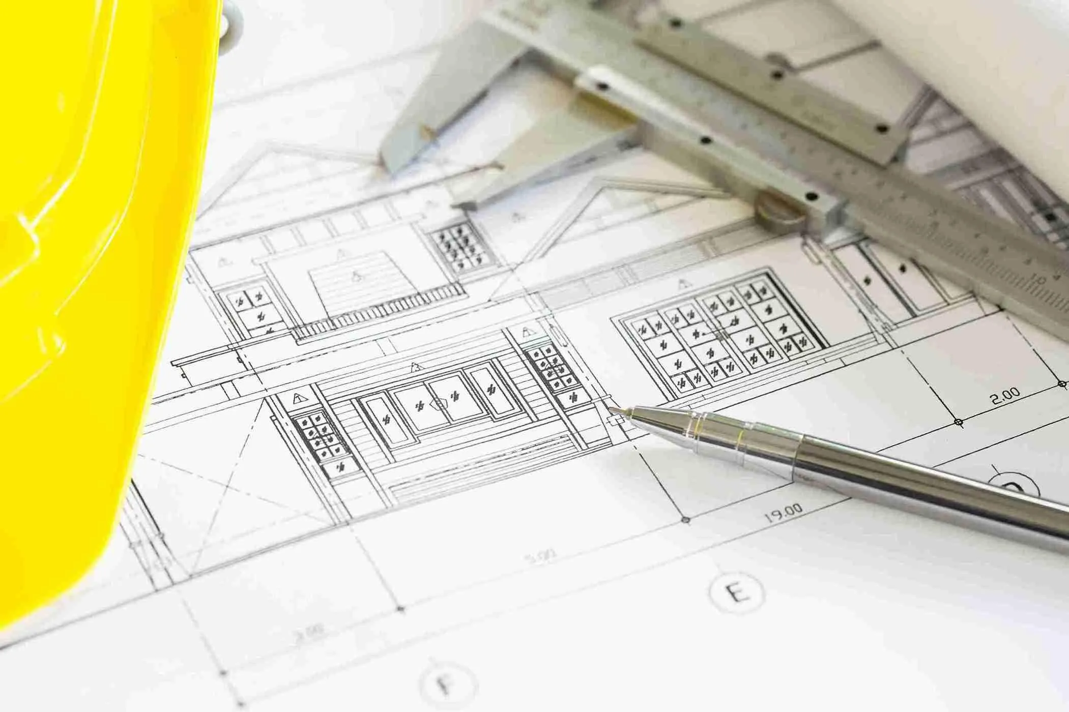 construction-plans-with-yellow-helmet-drawing-tools-bluep_11zon-1